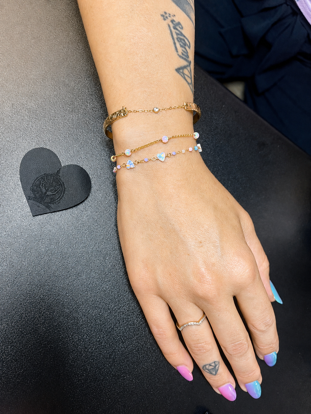 Layered permanent bracelets with colorful charms