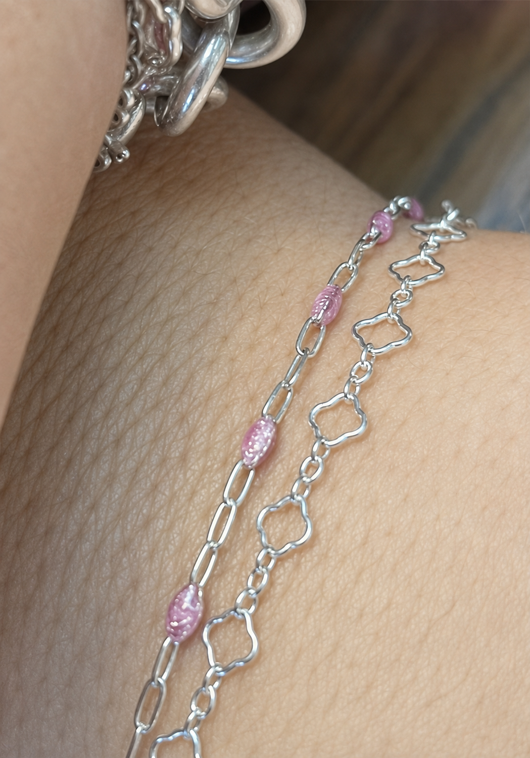 Close-up of two delicate permanent bracelets